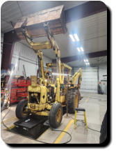 Tractor loader servicing